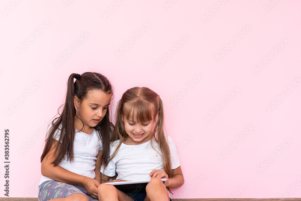 children, technology and home concept - two little girls with tablet pc computer on floor at home children, technology and home concept - two little girls with tablet pc computer on floor at home