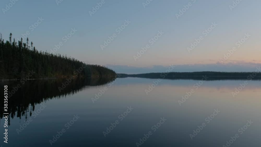 Camera pan from a fishing boat showing a quiet and calm lake at dusk Camera pan from a fishing boat showing a quiet and calm lake at dusk