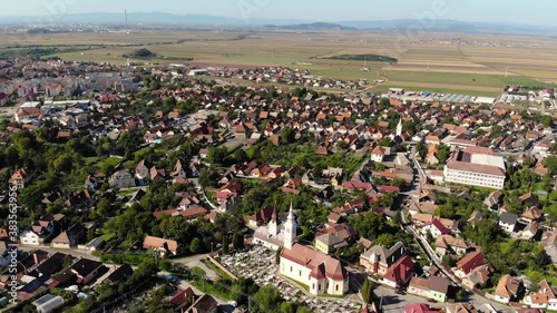 Flying over a church in Sacele on a sunny day photo