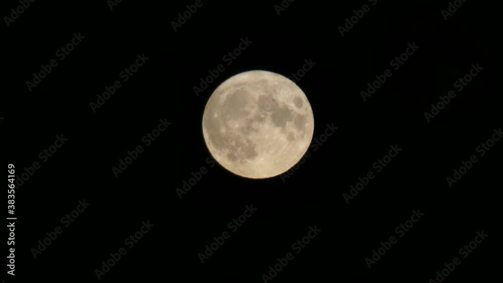 Full harvest moon crater surface closeup passing across dark Halloween sky Full harvest moon crater surface closeup passing across dark Halloween sky