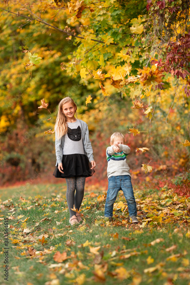 Happy little kids with autumn leaves in the park Happy little kids with autumn leaves in the park
