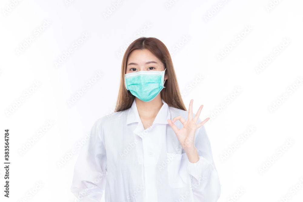 Beautiful portrait friendly asian female doctor or nurse wear medical mask at medical clinic isolated on white background. Mask to prevent virus concept.