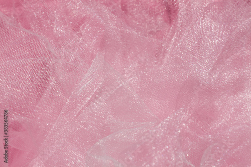 Pink tulle fabric texture top view. Coral background. Fashion color trends feminine tutu skirt flat lay, female blog backdrop for text signs desidgn. Girly abstract wallpaper, textile surface. © KawaiiS