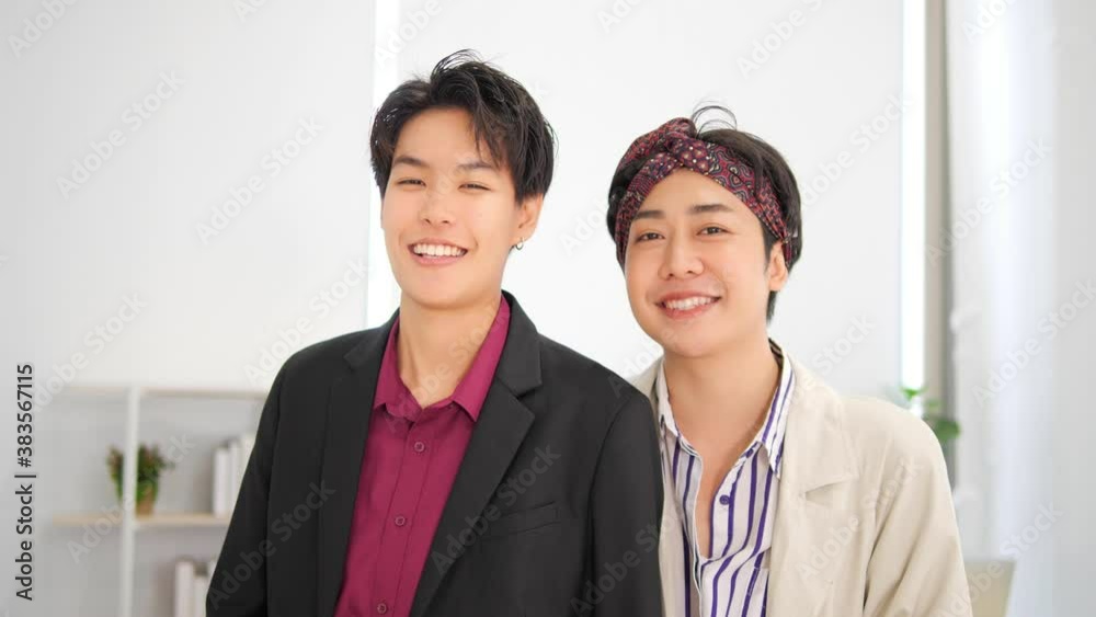 Portrait of Asian gay man and tomboy standing and look at camera in office business, LGBTQ with legal concept. Portrait of Asian gay man and tomboy standing and look at camera in office business, LGBTQ with legal concept.