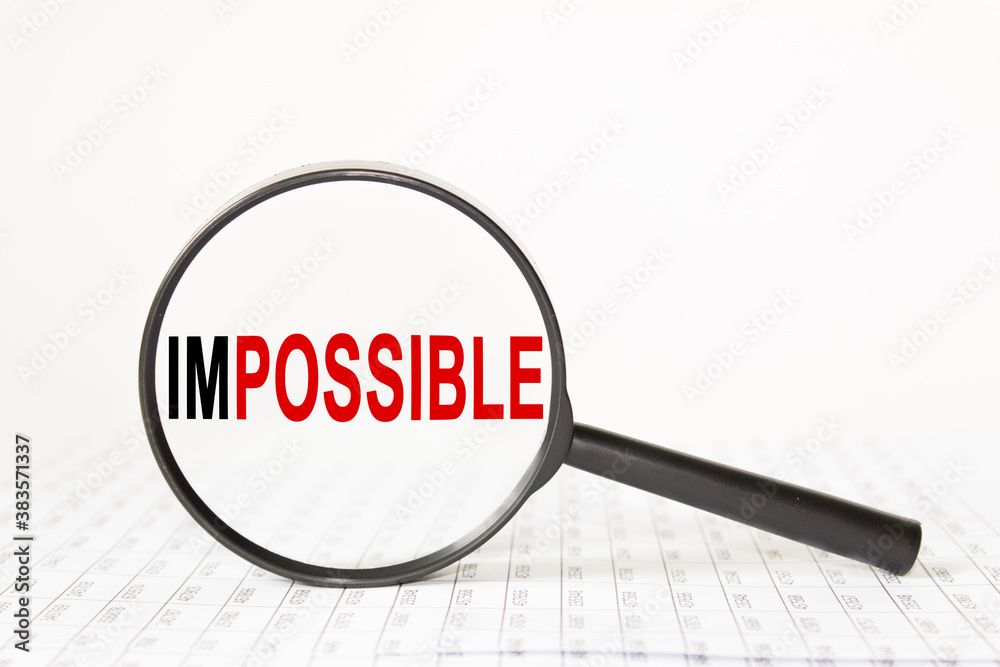 words IMPOSSIBLE in a magnifying glass on a white background. business concept words IMPOSSIBLE in a magnifying glass on a white background. business concept