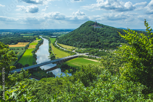 Emperor William Monument on top of Wittekindsberg and the Weser river on the left. Near the city of Porta Westfalica, North Rhine Westphalia, Germany. View from Portakanzel viewpoint.