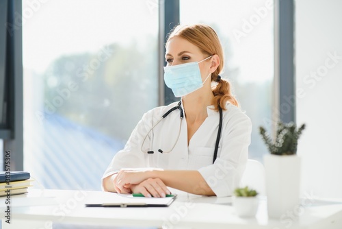 Doctor at hospital wearing medical mask to protect against coronavirus 2019 disease or COVID-19 global outbreak.