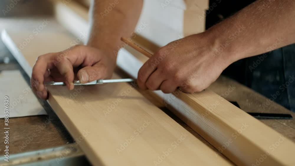 A carpenter with a caliper makes measurements. A man works with a tree. The carpenter takes measurements. Woodworking and traditional carpentry, craftsmanship, handwork concept. A carpenter with a caliper makes measurements. A man works with a tree. The carpenter takes measurements. Woodworking and traditional carpentry, craftsmanship, handwork concept.