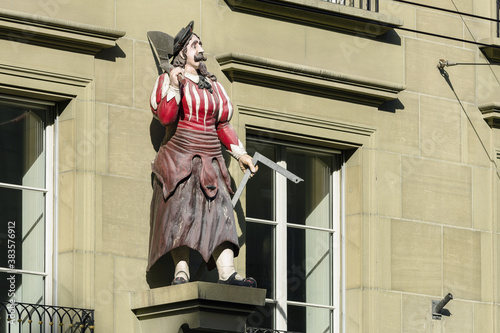 The statue of the butcher decorates frontage of a building in the old town of Bern, Switzerland photo