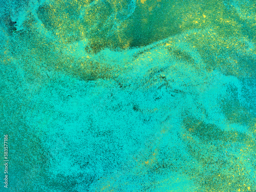 Turquoise grunge background with gold.