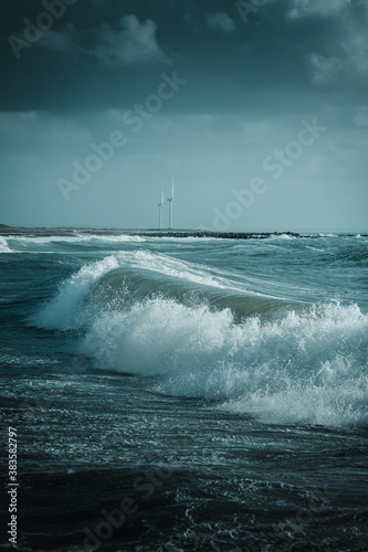Wild North sea storm at a harbor with heavy storm waves on a dark rainy weather day in Denmark