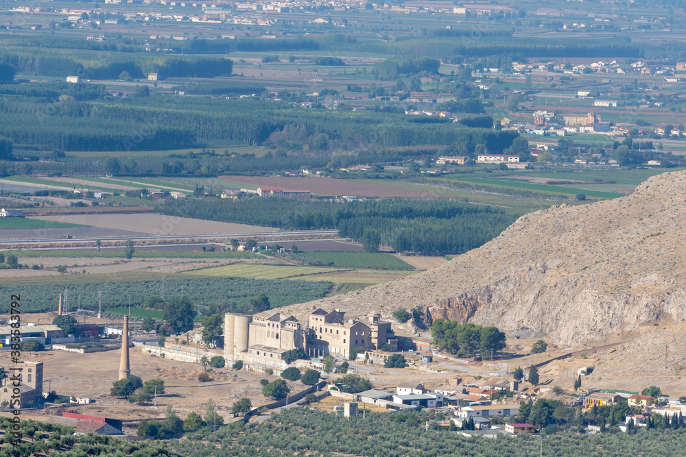 Distant view of the ruins of the first beet sugar factory in Spain next to Sierra Elvira in the Granada town of Atarfe