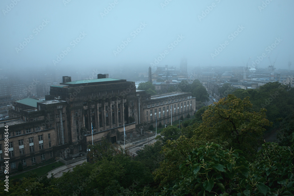 View of Edinburgh covered in fog from Calton Hill and St. Andrews House is the headquarters building of the Scottish Government