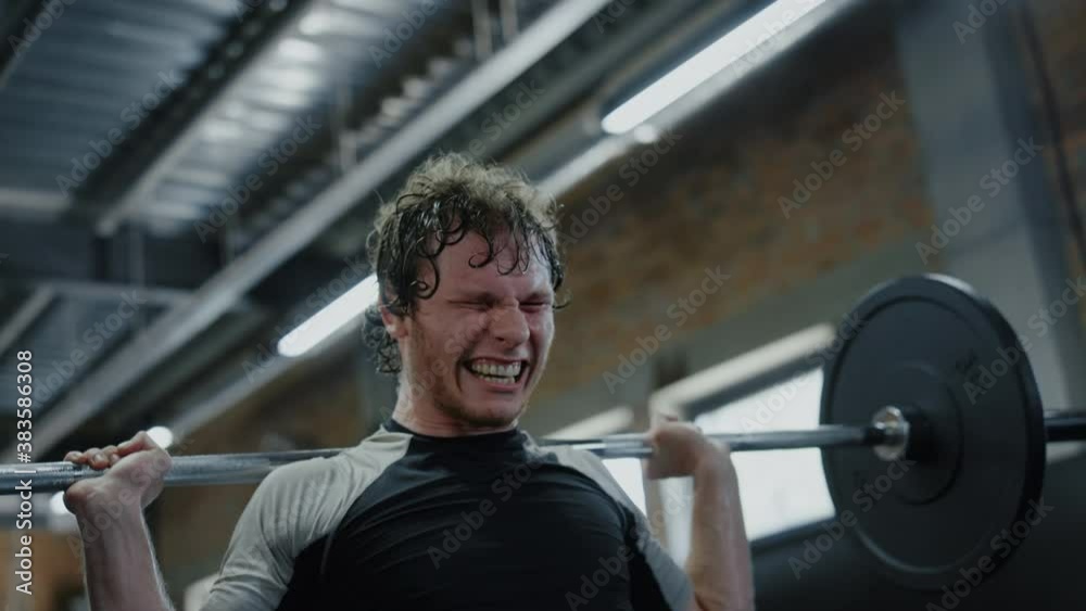 Ambitious sportsman doing powerlifting in sport club. Kickboxer showing power