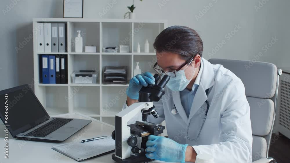 Professional medical doctor working in laboratory using microscope. Professional medical doctor working in laboratory using microscope.