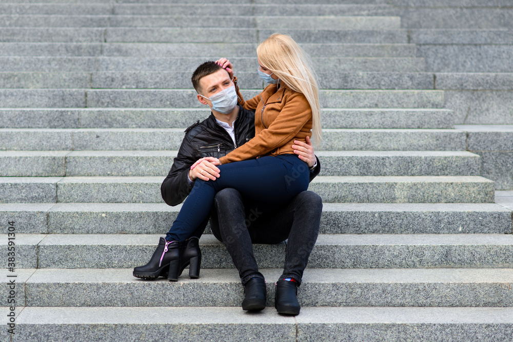 Young couple in protective medical mask on face outdoor at street. Guy and girl in virus protection.