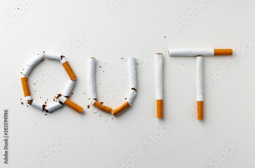 Inscription word QUIT made out of cigarettes top view
