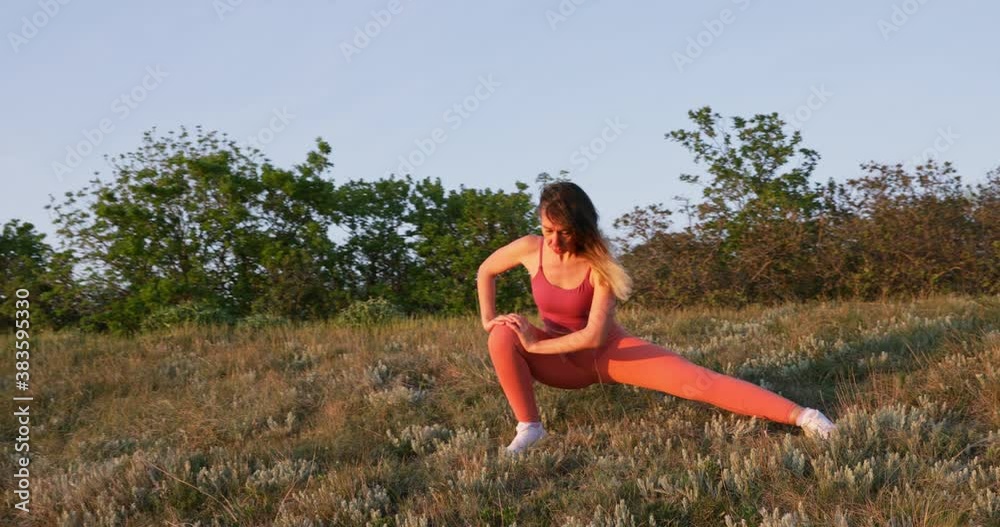 Sporty fit woman doing fitness aerobic exercises in outdoor at sunset or sunrise. Workout, training and wellness concept. Sporty fit woman doing fitness aerobic exercises in outdoor at sunset or sunrise. Workout, training and wellness concept.