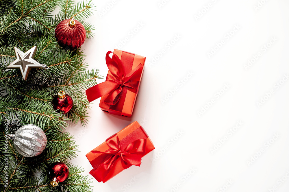 Postcard, frame, banner. New Year. Christmas handmade gift boxes and fir trees on white background with copy space for your text Postcard, frame, banner. New Year. Christmas handmade gift boxes and fir trees on white background with copy space for your text