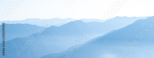 Mountain range banner. Rocky mountains in morning haze © ilyaska