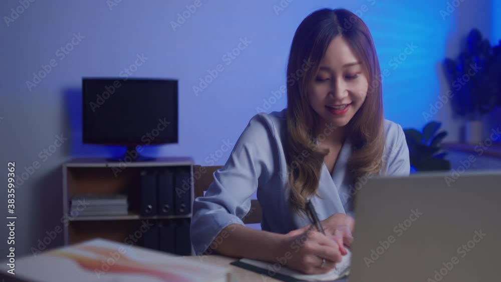 Young business Chinese woman using laptop as webcam working from home late at night for business meeting, New normal concept Young business Chinese woman using laptop as webcam working from home late at night for business meeting, New normal concept
