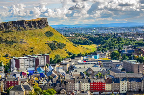 Edinburgh citiscape view with houses and Salisbury crags, Scotla photo