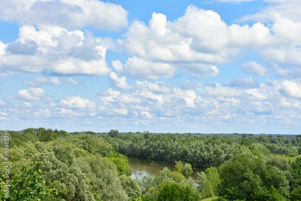 Obraz premium Landscape view of the Seim River (Ukraine), surrounded by trees and meadows near wooden Cossack fortress, Baturin, Ukraine