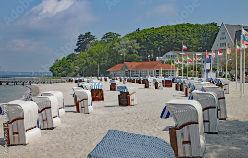 Beach scene with typical hooded windbreak chairs on a quiet beach in Schleswig-Holstein in Germany
