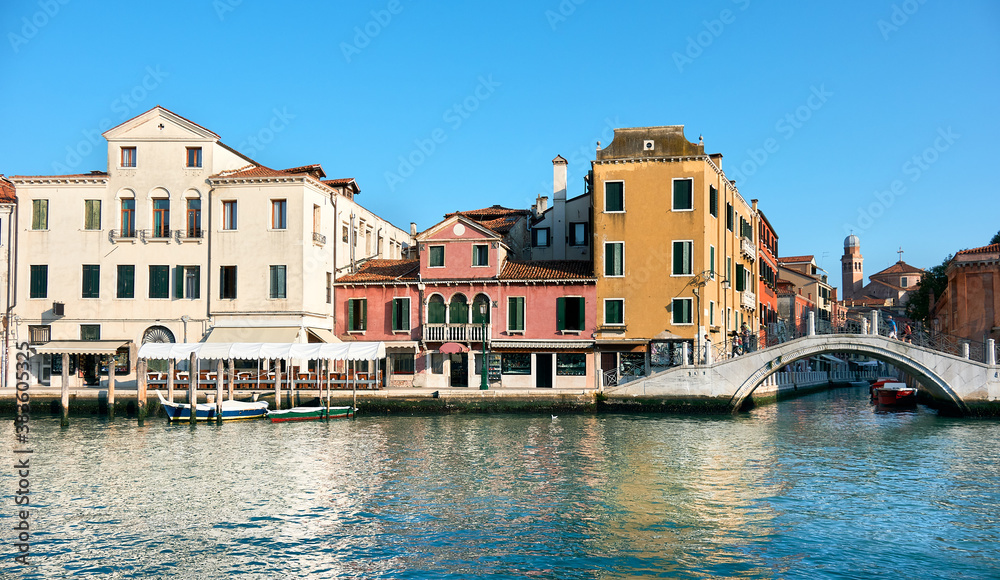 Traditional houses and foot bridge, view from Grand Canal in Venice, Italy.