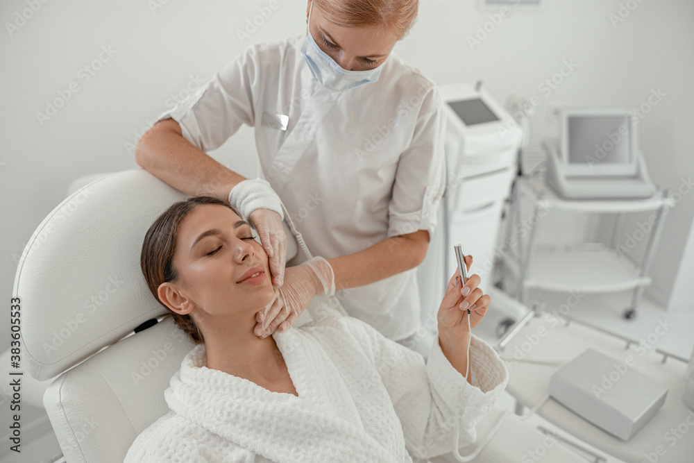 Beautiful healthy smiling caucasian woman is doing beauty procedures at spa and healthcare salon