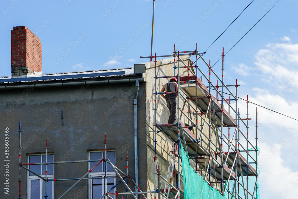 repair of the facade of a residential house using scaffolding