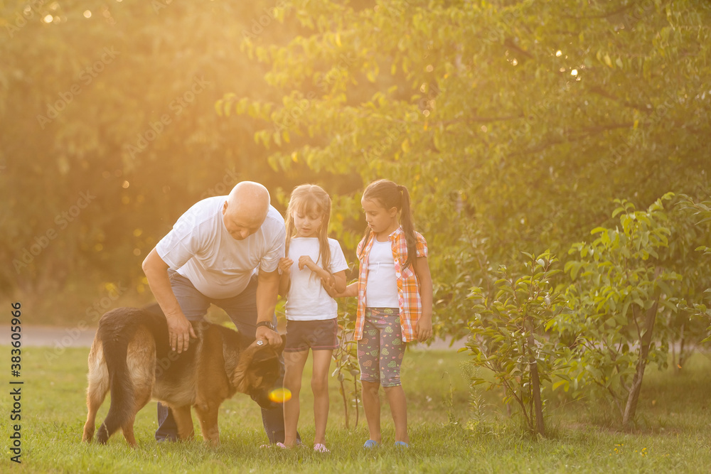 Obraz premium Grandfather And Granddaughters Taking Dog For Walk