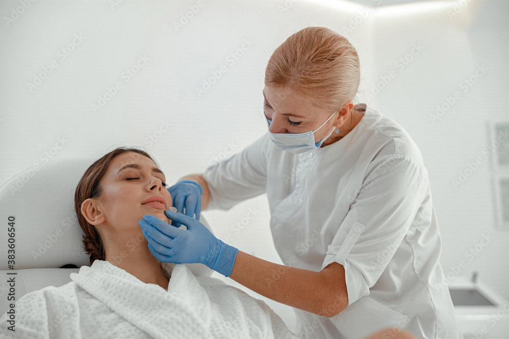 Beautiful healthy smiling caucasian woman is doing beauty procedures at spa and healthcare salon Beautiful healthy smiling caucasian woman is doing beauty procedures at spa and healthcare salon