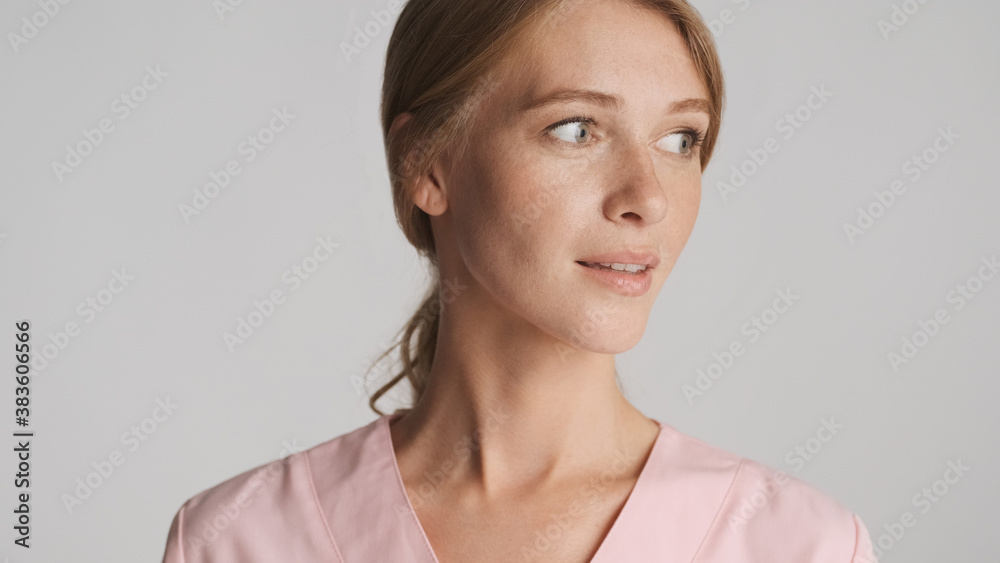 Portrait of beautiful female doctor looking away over white back Portrait of beautiful female doctor looking away over white back