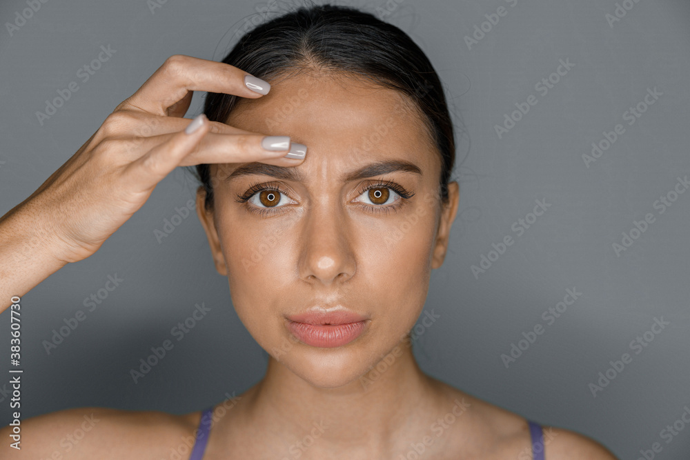 Fototapeta premium Beautiful healthy smiling caucasian woman is doing beauty procedures at spa and healthcare salon