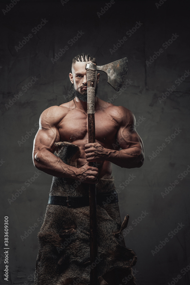 Brutal and powerful viking warrior with dreadlocks and beard posing
