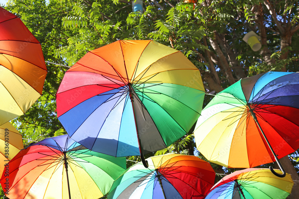 rainbow umbrellas hanging from the ceiling - umbrella decoration