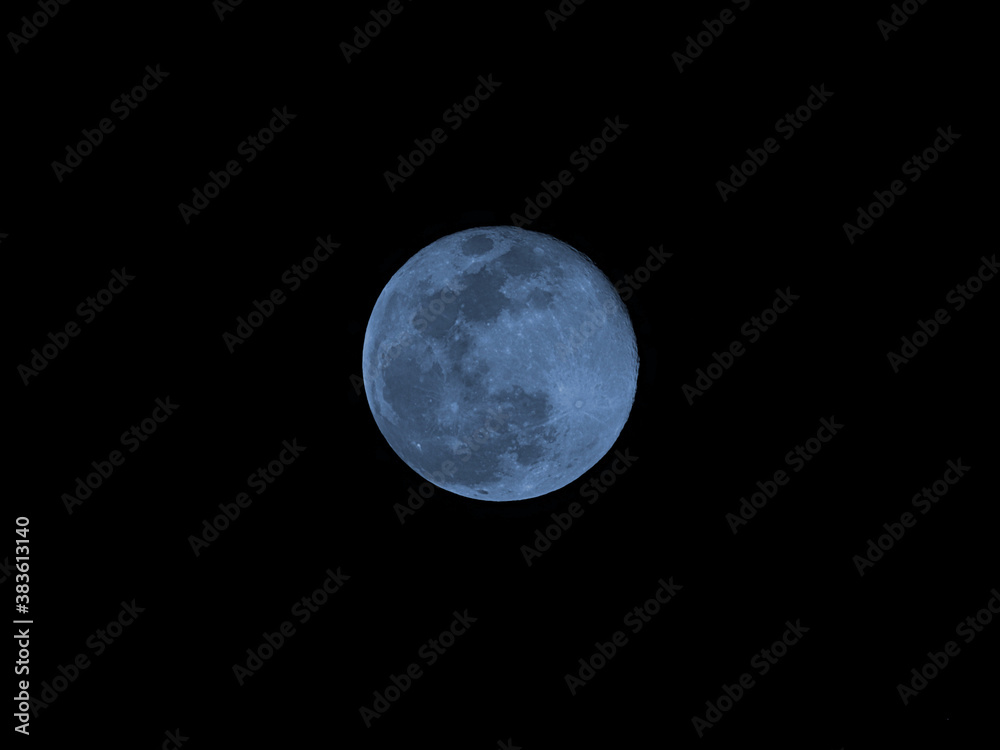 Blue moon of Halloween also called Harvest moon twice in month of October a full moon glowing in night sky Blue moon of Halloween also called Harvest moon twice in month of October a full moon glowing in night sky
