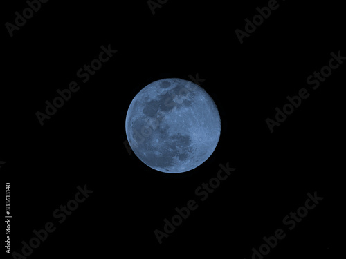 Blue moon of Halloween also called Harvest moon twice in month of October a full moon glowing in night sky 