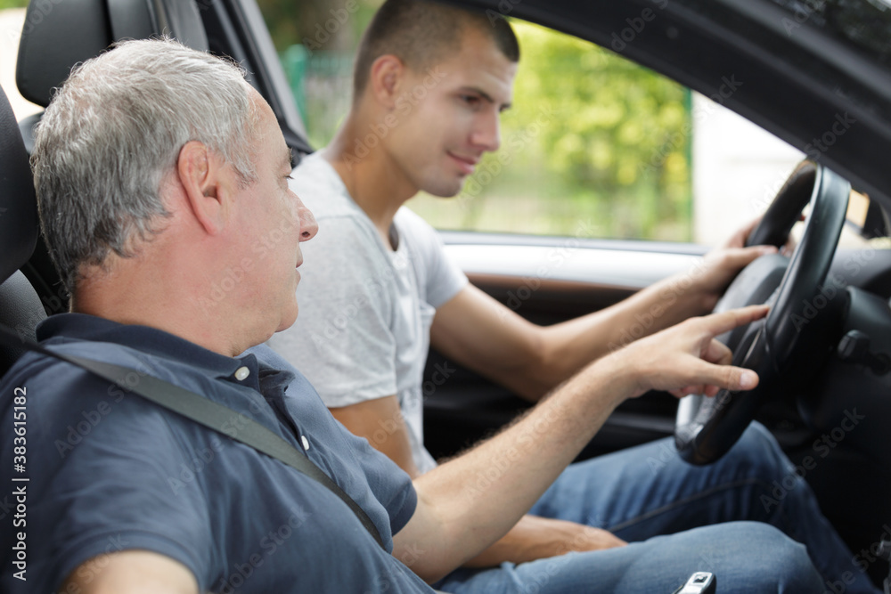 young man having a accompanied driving lesson - obrazy, fototapety, plakaty 