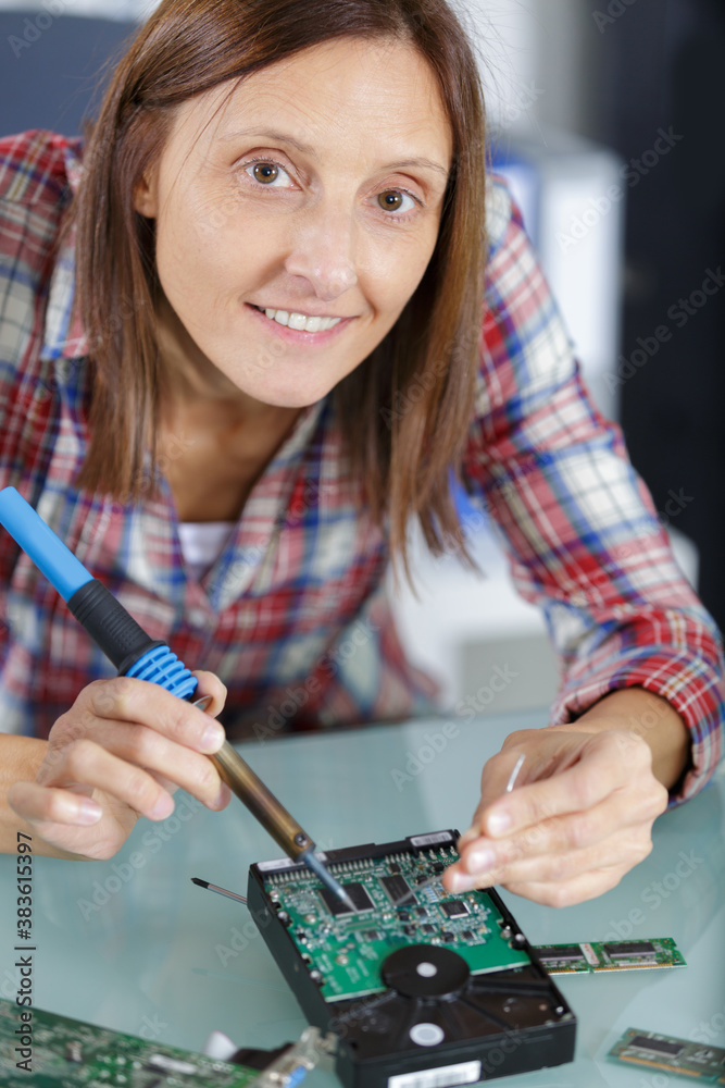 a female pc technician soldering pc part