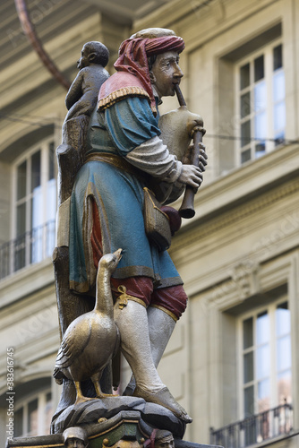 The Pfeiferbrunnen fountain depicts the minstrel, playing the bagpipes, standing on the colorful pillar in Bern, Switzerland