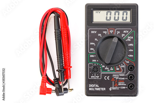 Digital electrical tester multimeter in black case isolated on white background. Digital multimeters have a numeric display, can measure voltage, current and resistance. Close-up. photo