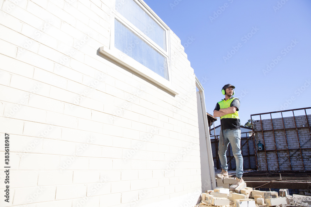 A builder working at height on on construction A builder working at height on on construction