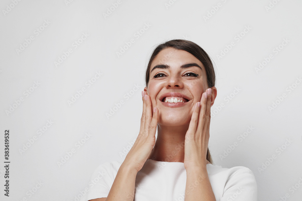 Beautiful young pretty smiling woman posing isolated over white wall background. Space for text.