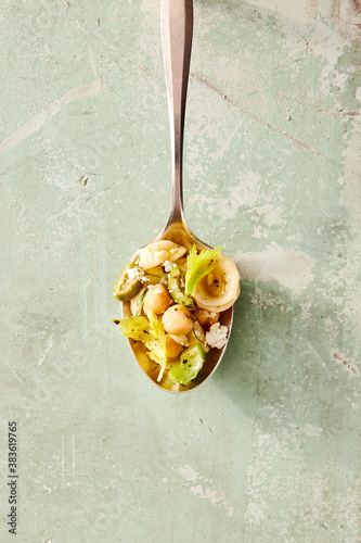 Overhead view of pasta and chickpeas served in spoon