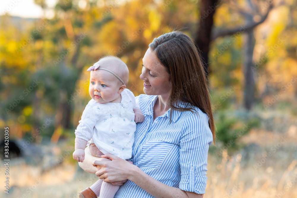 Young mum holding her baby daughter Young mum holding her baby daughter