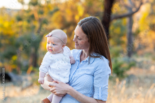 Young mum holding her baby daughter photo
