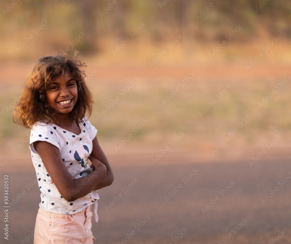 smiling young girl standing outdoors with arms crossed smiling young girl standing outdoors with arms crossed