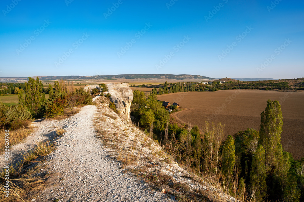A rock with a view of a wide valley, summer nature scenery at sunset A rock with a view of a wide valley, summer nature scenery at sunset